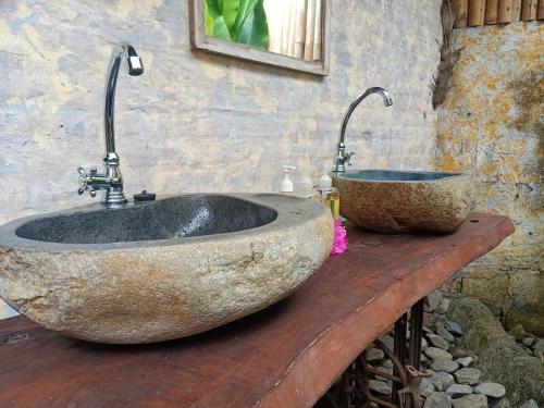 a bathroom with two sinks on a wooden counter at Funky Place in Lovina