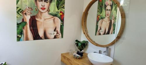 a bathroom with two pictures of a woman on the wall at Kingsley House Chalet in Ballito