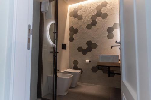 a bathroom with two toilets and a sink at Teo House Beach in Taormina