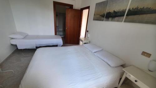 a bedroom with two beds and a picture on the wall at Nonno Attì in Castel San Lorenzo
