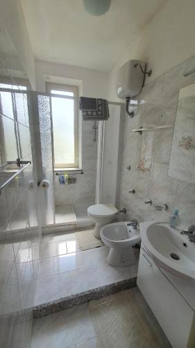 a bathroom with a toilet and a sink and a shower at Nonno Attì in Castel San Lorenzo