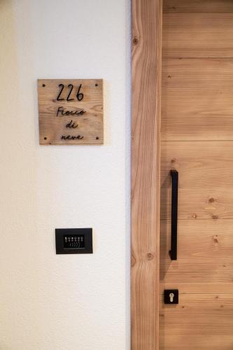 a door with a sign that reads faster than me at Sci Sport rooms & suites in Bormio