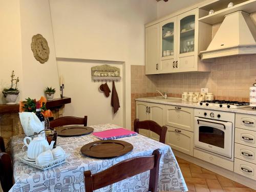 a kitchen with a table with two plates on it at Casina di Rosa in Civitella Marittima