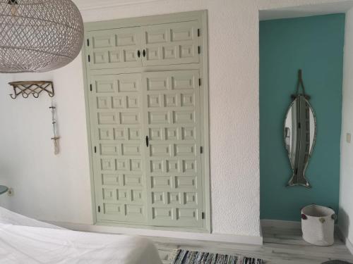 a bedroom with a white door in a room at Ca Olivar in Teulada