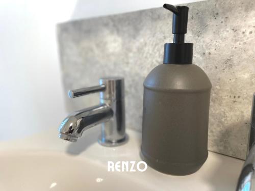 a soap dispenser sitting on a sink next to a faucet at Spacious 2 Bedroom home in Lincoln by Renzo, Victorian Townhouse, Flexible Check-In! in Lincolnshire