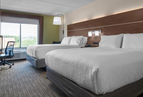 a hotel room with two beds and a window at Holiday Inn Express North Myrtle Beach - Little River by IHG in Little River