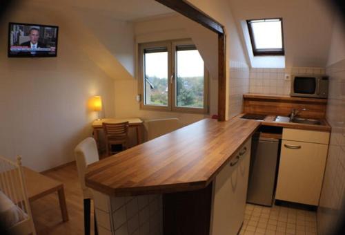 a kitchen with a wooden counter top in a room at Le Relais in Düsseldorf