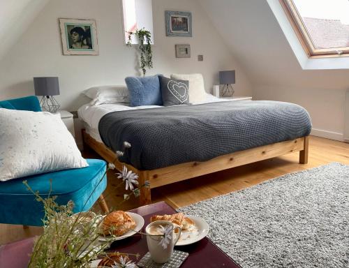 a bedroom with a bed and a table with food on it at Detached annex in centre of Woodstock, Cotswolds in Woodstock
