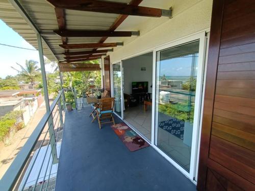 a balcony of a house with a view of the ocean at Surf house holidays in Baie du Cap