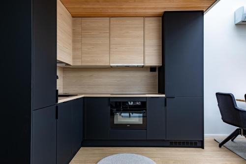 una cocina con armarios negros y horno negro en Levin Primus en Levi