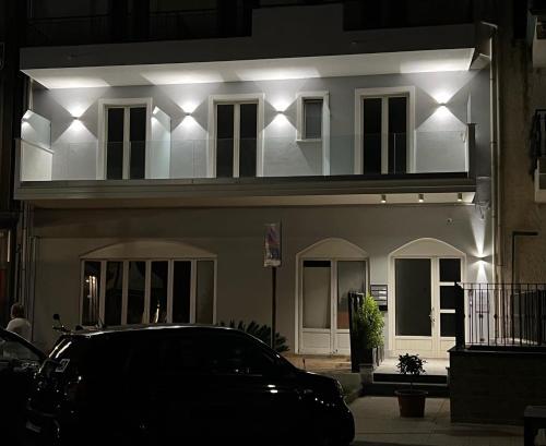 a car parked in front of a building with lights at I Mori dell’Etna in Giardini Naxos
