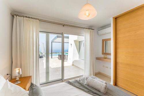 a bedroom with a bed and a view of the ocean at Chalet Golf Costa Adeje 3A003 in Adeje