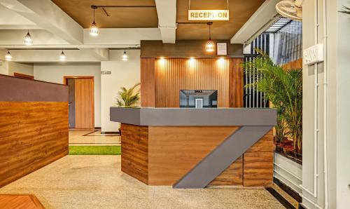 a lobby with a reception desk in a building at Treebo Trend Worldtree Manyata Thanisandra in Bangalore