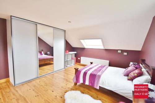 a bedroom with a bed and a large mirror at Sheelagh's Kitchen in Ballyferriter