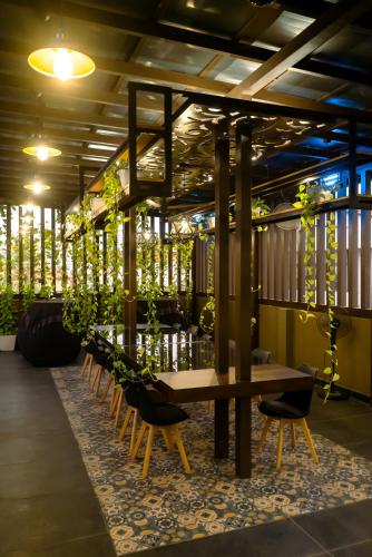 a table and chairs in a room with plants at Retrieve Health & Wellness in Cochin