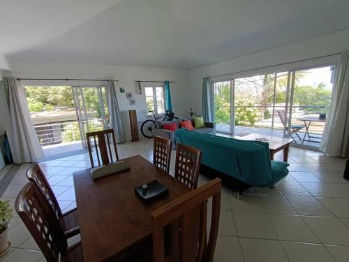 a living room with a couch and a table at Surf house holidays in Baie du Cap