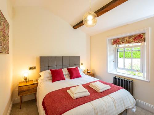 a bedroom with a large bed with red pillows at Old Rectory House in Newtown