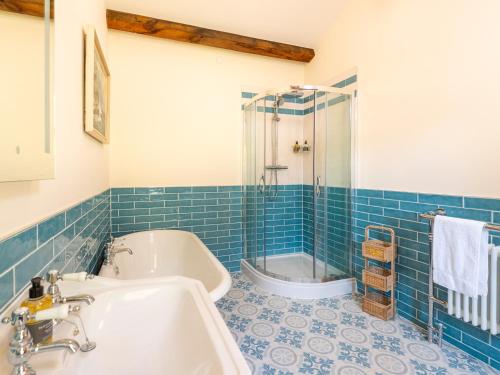 a bathroom with a tub and a sink and a shower at Old Rectory House in Newtown