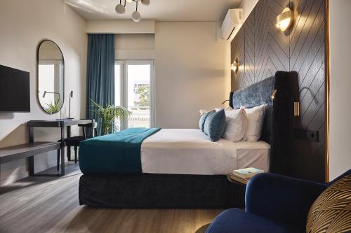 a hotel room with a bed and a desk at Acropolis Panorama Residence in Athens