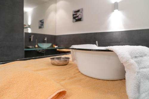 a bathroom with a bath tub and a sink at Hotel Yachtclub in Timmendorfer Strand