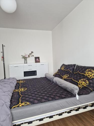 a bed in a room with a bed frame at Kawalerka na pierwszym piętrze in Malbork