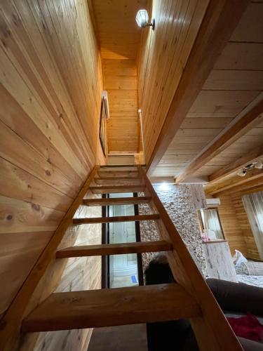 a staircase in a house with wooden ceilings at Cosy cottage Andrej in Danilovgrad