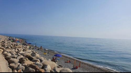 a group of people on a beach near the water at Casa Acquamarina in Marina di Monasterace