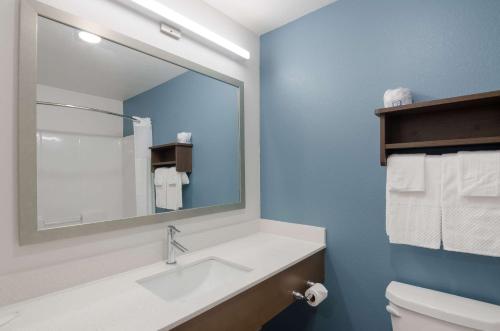 a bathroom with a sink and a mirror at WoodSpring Suites Lynchburg VA in Lynchburg