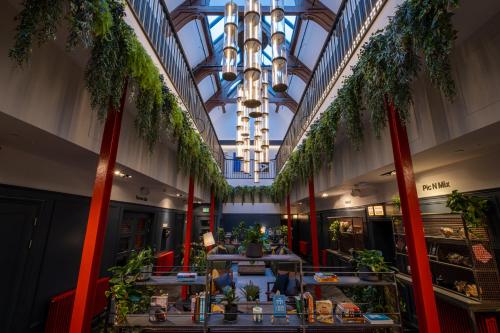 a lobby with palm trees and a chandelier at BrewDog DogHouse Edinburgh in Edinburgh