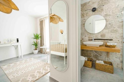 a bathroom with a sink and a mirror at Voger Alaçatı Köyiçi in Alacati