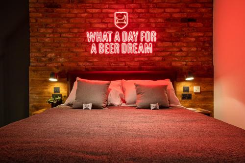a bedroom with a bed with a neon sign above it at BrewDog DogHouse Edinburgh in Edinburgh