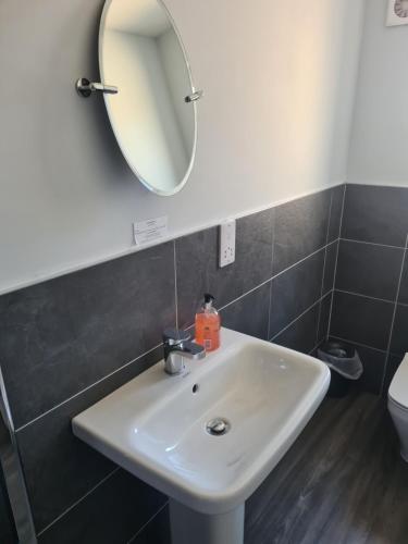 a bathroom with a white sink and a mirror at The Finch Hatton Arms in Sleaford