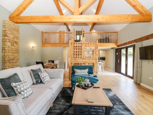 a living room with a couch and a table at Petals Patch in Cheltenham