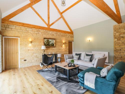 a living room with a brick wall at Petals Patch in Cheltenham