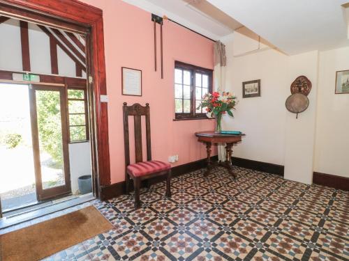 a room with a table and a vase of flowers at Heselwood in Lyme Regis