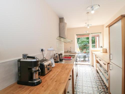 a kitchen with a counter with a coffee maker on it at Heselwood in Lyme Regis