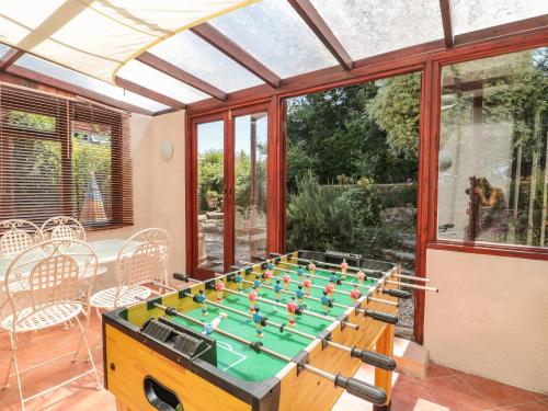 a room with a table with a foosball at Heselwood in Lyme Regis
