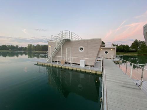 a house on a dock on a body of water at Blue Village in Savigliano