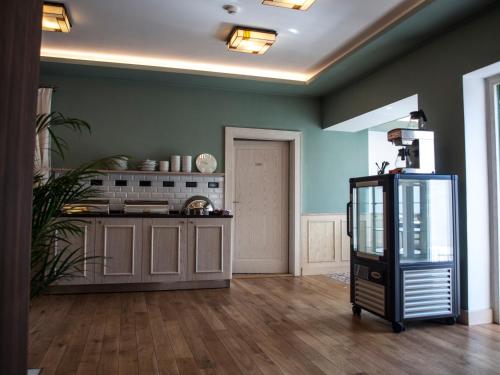 a kitchen with green walls and a counter in a room at Hotel U Parku in Hořovice