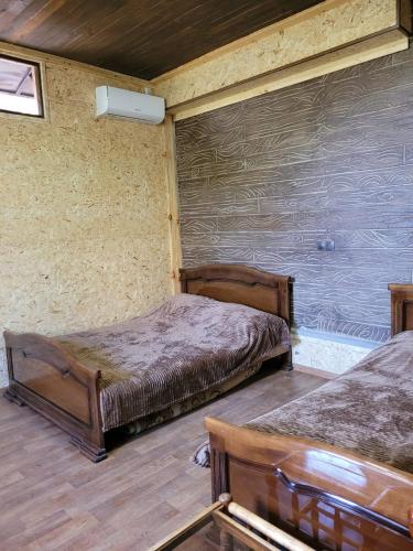 a bedroom with two beds and a wall at Holiday House in Yerevan with Garden and Lovely Views in Yerevan