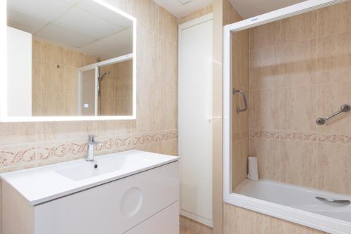y baño con lavabo blanco y espejo. en Patacona Breeze, en Valencia