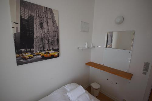 a bedroom with a picture of a yellow taxi at Egtved Hotel in Egtved