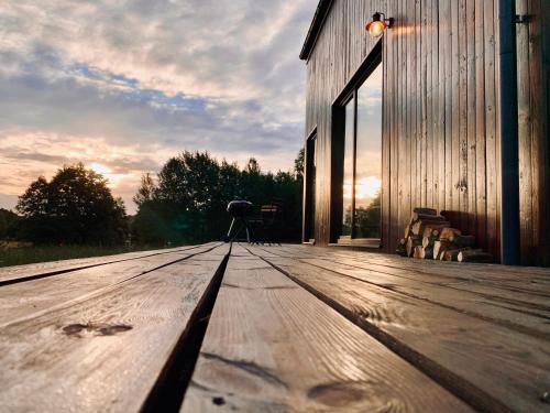 a wooden deck with a camera on the side of a building at Domek Trzy Rzeki in Załęże