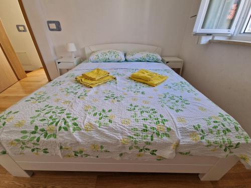 a bed with two yellow towels on top of it at Beautiful house Lanna in Izola