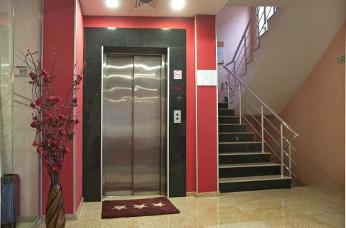 a elevator in a building with a stair case at Hotel Real in Plovdiv