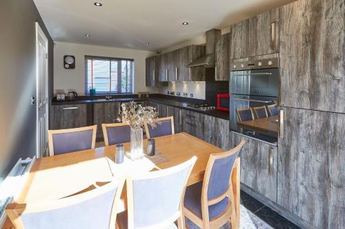 a kitchen with a dining room table and chairs at Host & Stay - Greenfinch Road in Coventry