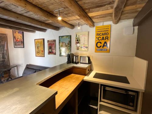 a kitchen with a counter and a stove top oven at Le Hameau du Buron - "La Taverne" - Option SPA in Eyzin-Pinet