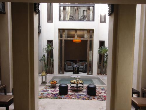a lobby with a pool in the middle of a building at Riad Vanilla Sma & Spa in Marrakesh