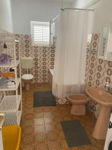 a bathroom with a sink and a toilet and a shower at Apartment MPPM in Orebić