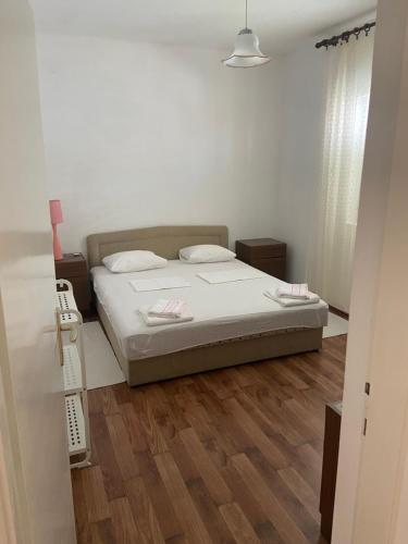 a bedroom with a bed and a wooden floor at Apartment MPPM in Orebić